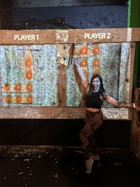 a woman is standing in front of a large screen