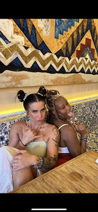 two women sitting at a table in a restaurant