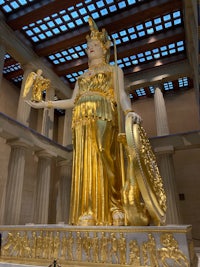 a large statue of a greek goddess in a museum