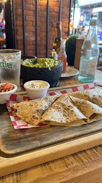 a plate of quesadillas on a wooden table