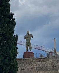 a statue of a man on top of a hill